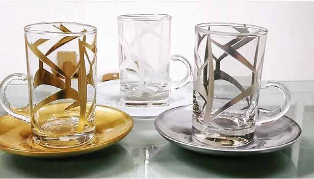 Three glass cups and saucers with gold, clear, and silver geometric decoration