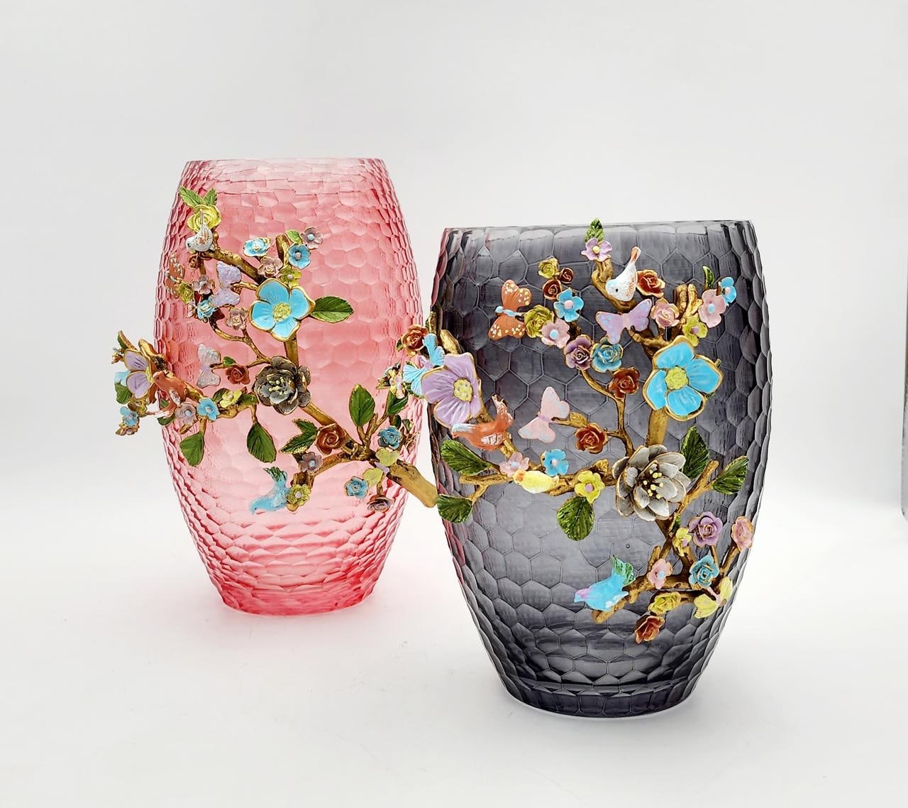 Pink and smoked-grey faceted glass vases decorated with enamel flowers and butterflies