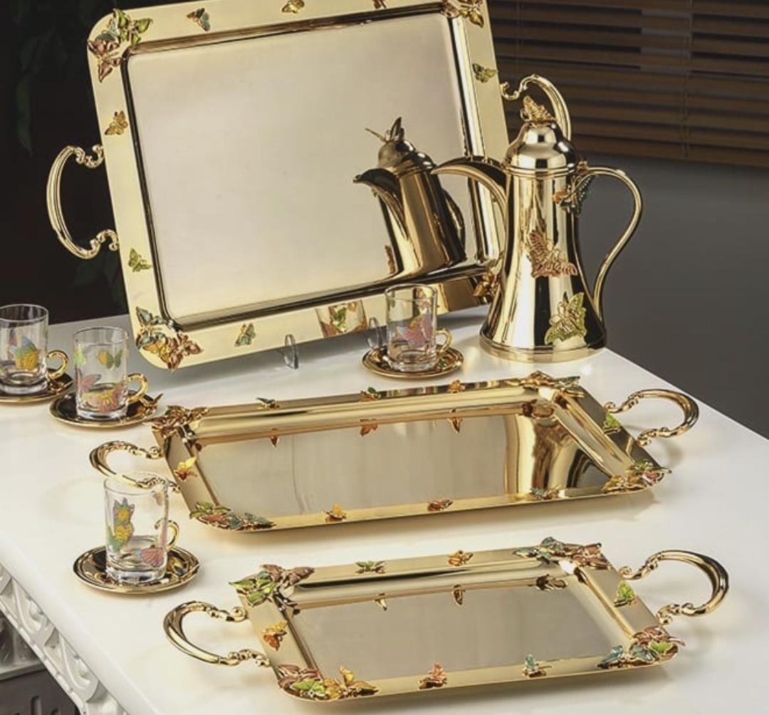 Gold-plated trays, coffee pots and glass cups decorated with small enamel butterflies