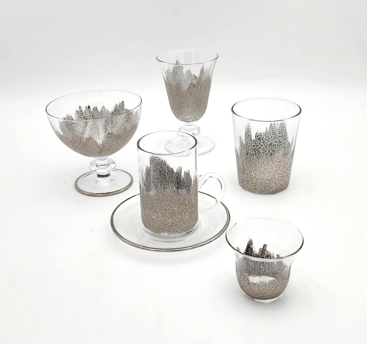 Clear glassware set — coupe, goblet, tumbler, cup and saucer — decorated with silver foliage