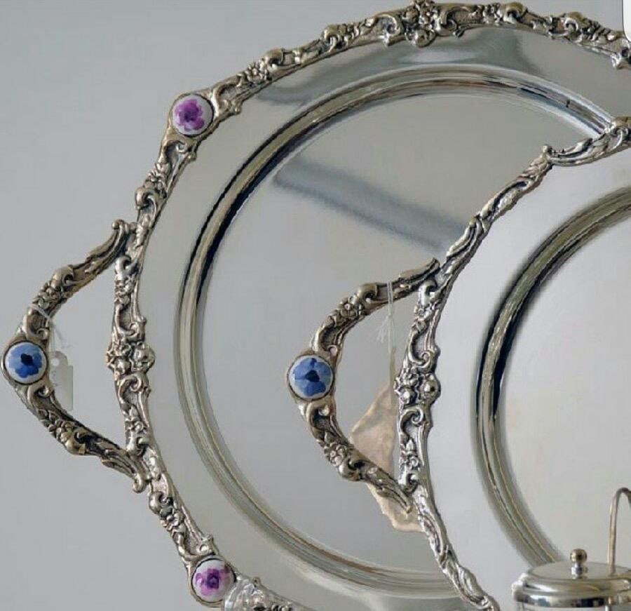 Oval silver trays with ornate scrolled rims set with blue and purple stones